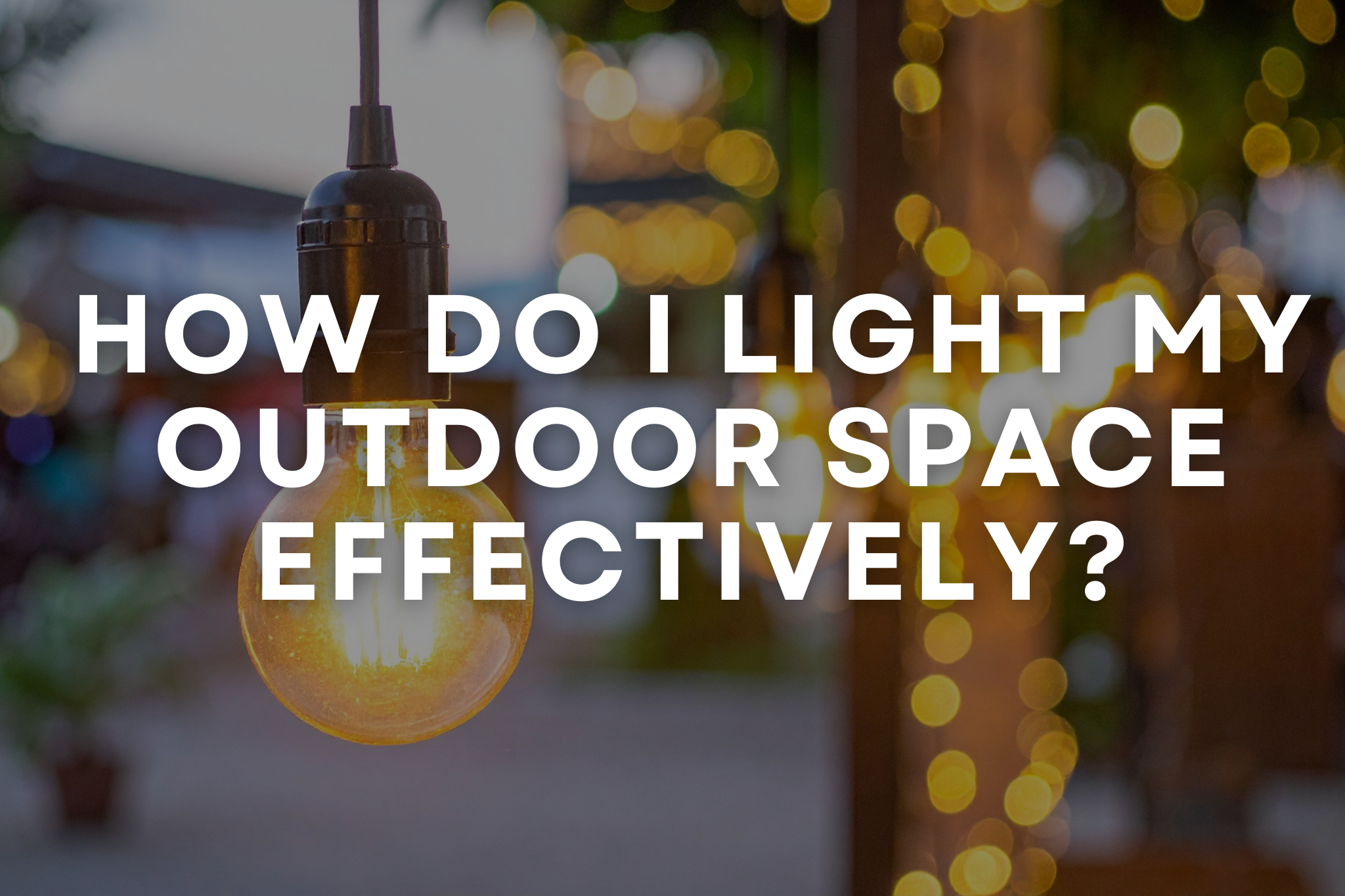 Warm, layered outdoor lighting across a landscaped backyard at dusk