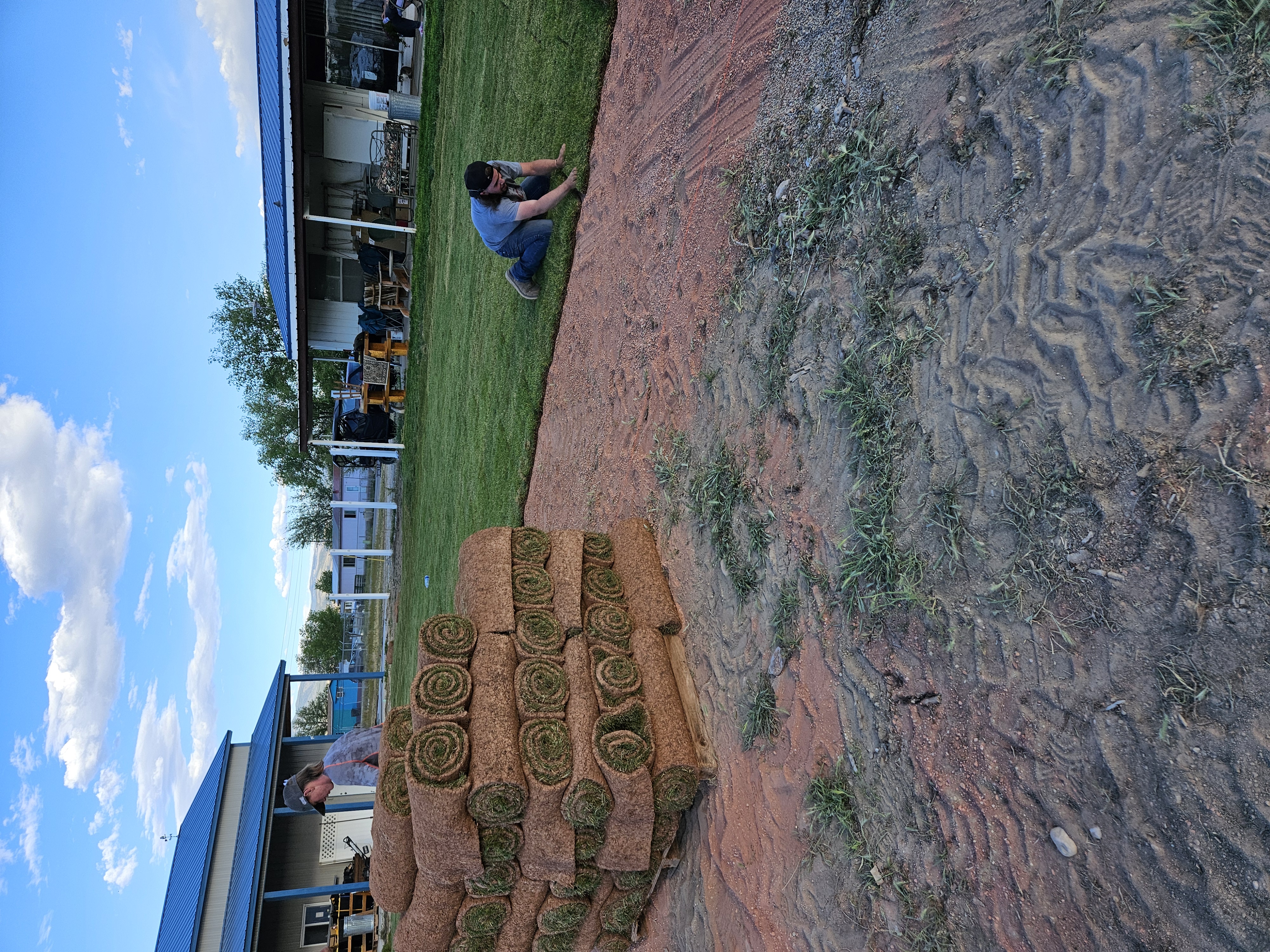 Front yard landscape beds with decorative rock edging and fresh mulch