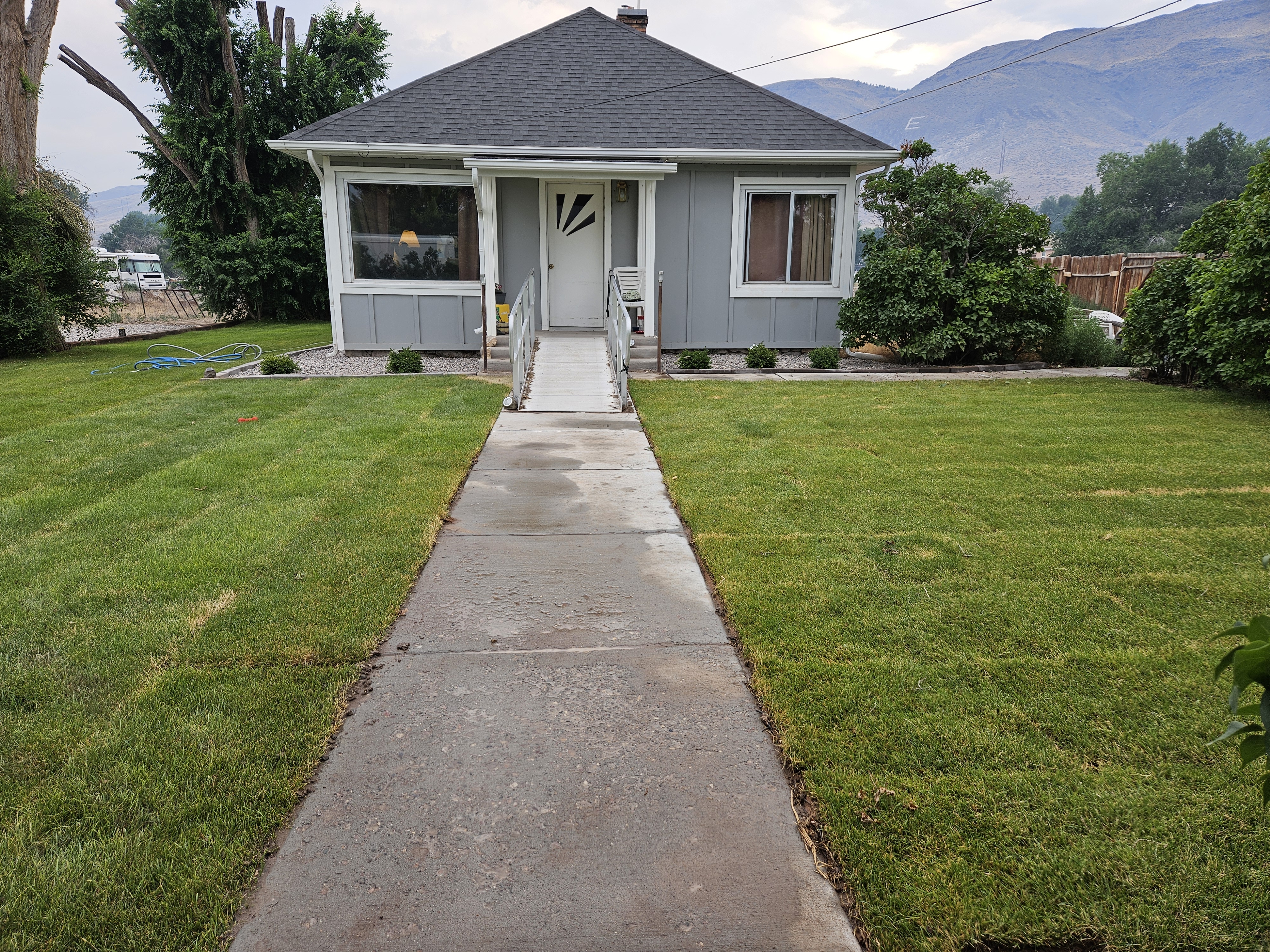Residential sprinkler system being installed with zone coverage across a lawn