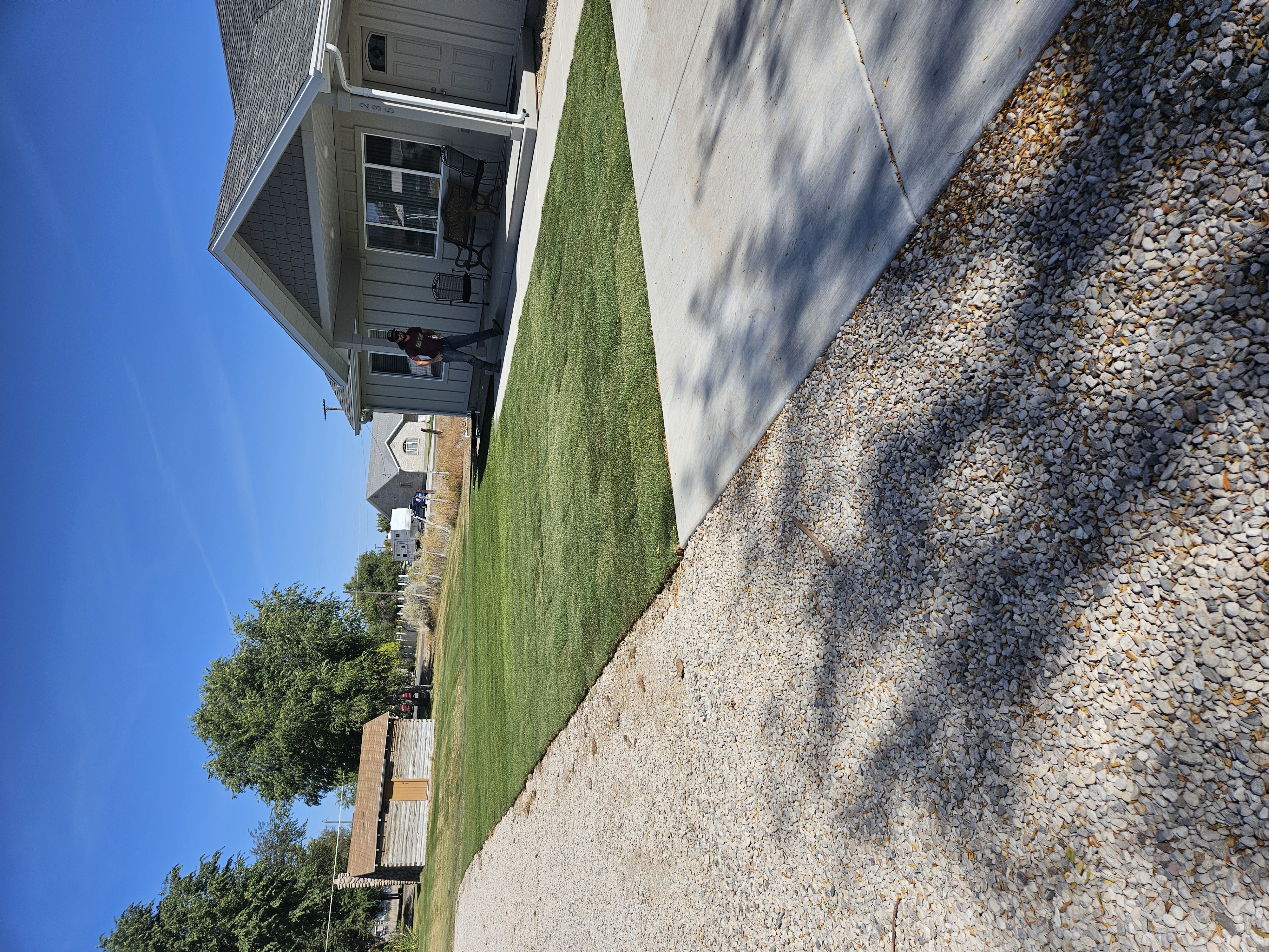 Custom concrete curbing edging installed around landscape planting beds