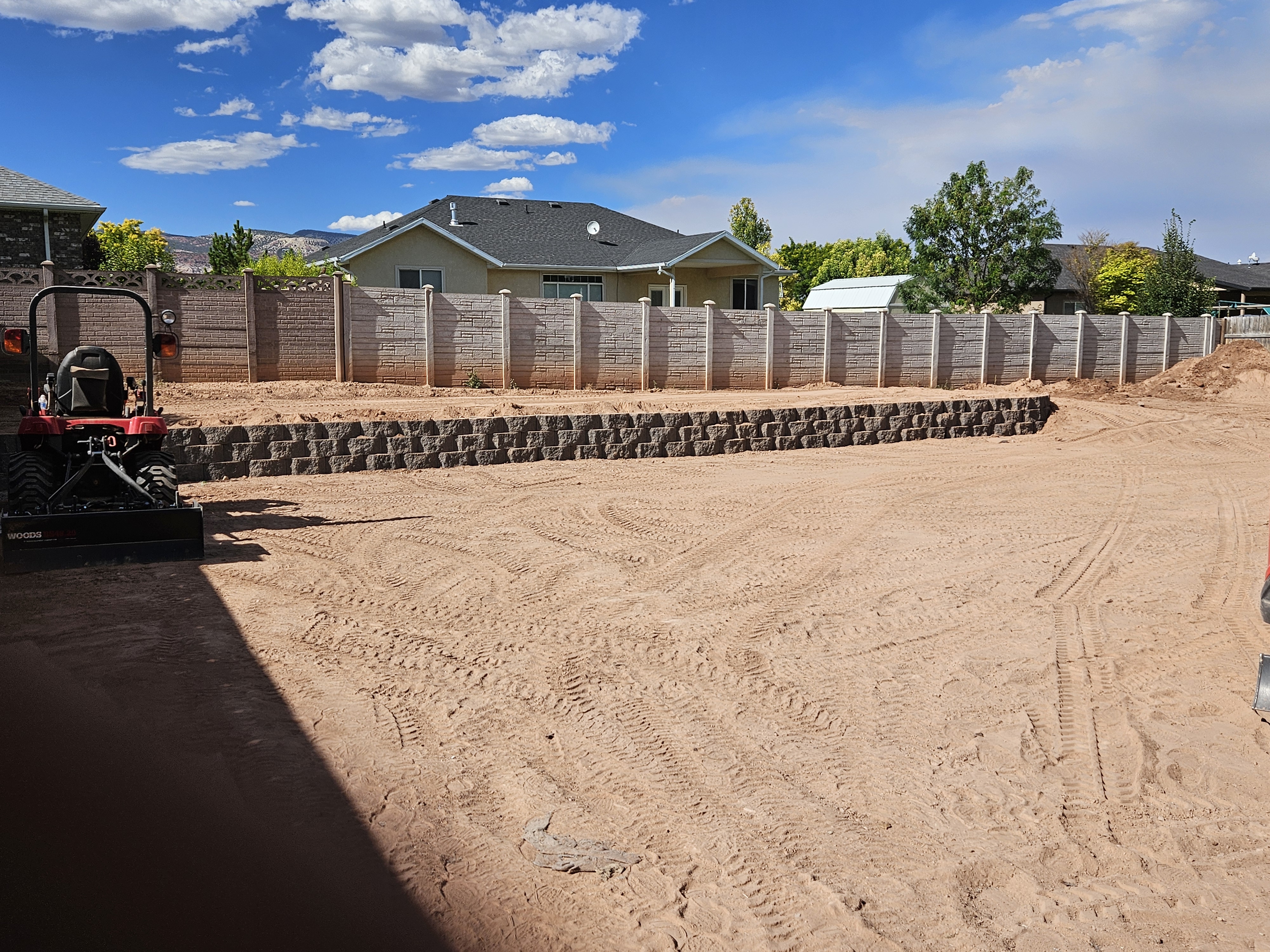 Low-maintenance landscape with ornamental grasses, natural boulders, and decomposed granite