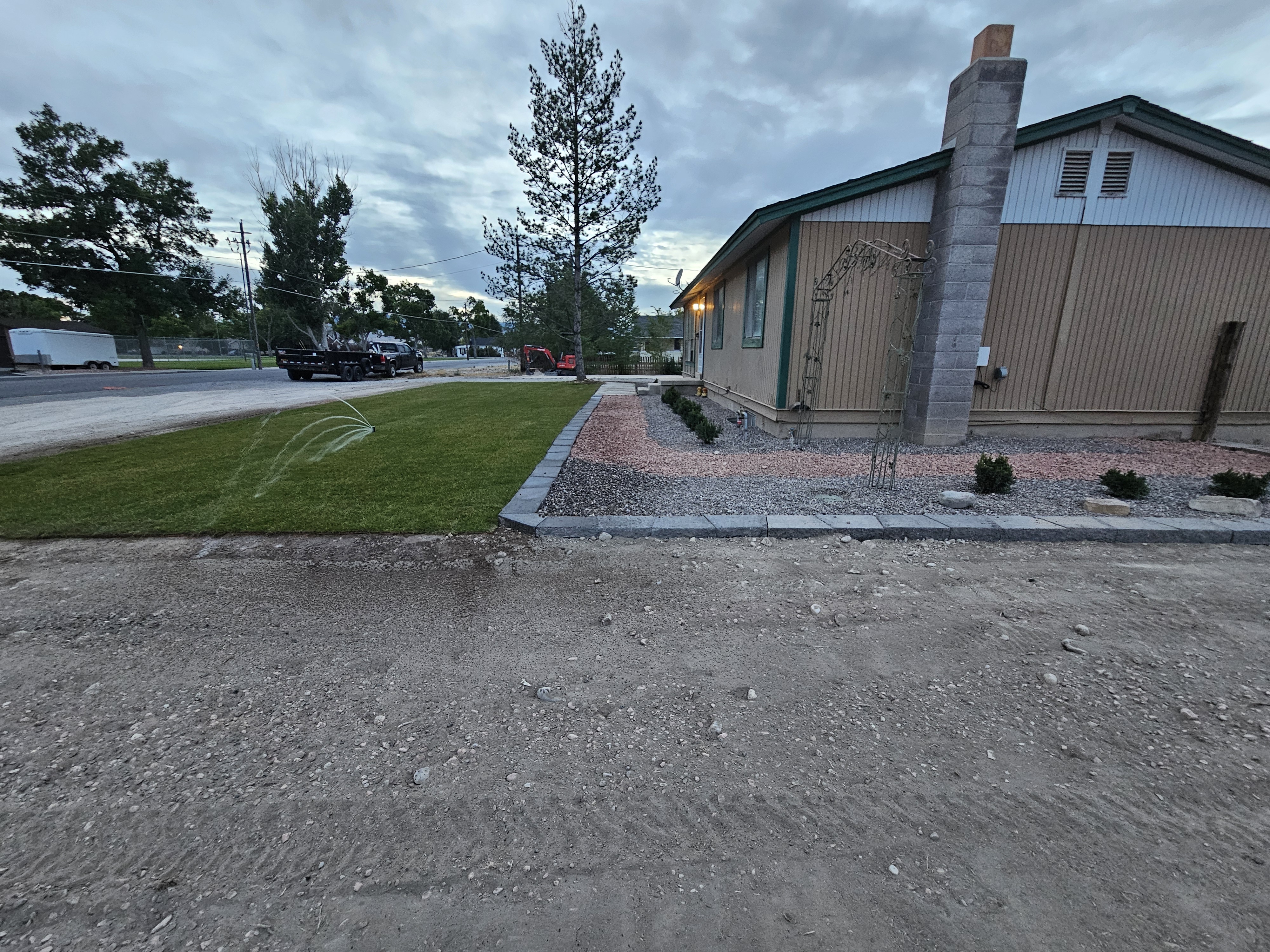 Commercial parking lot landscape strips with low-maintenance shrubs and mulch