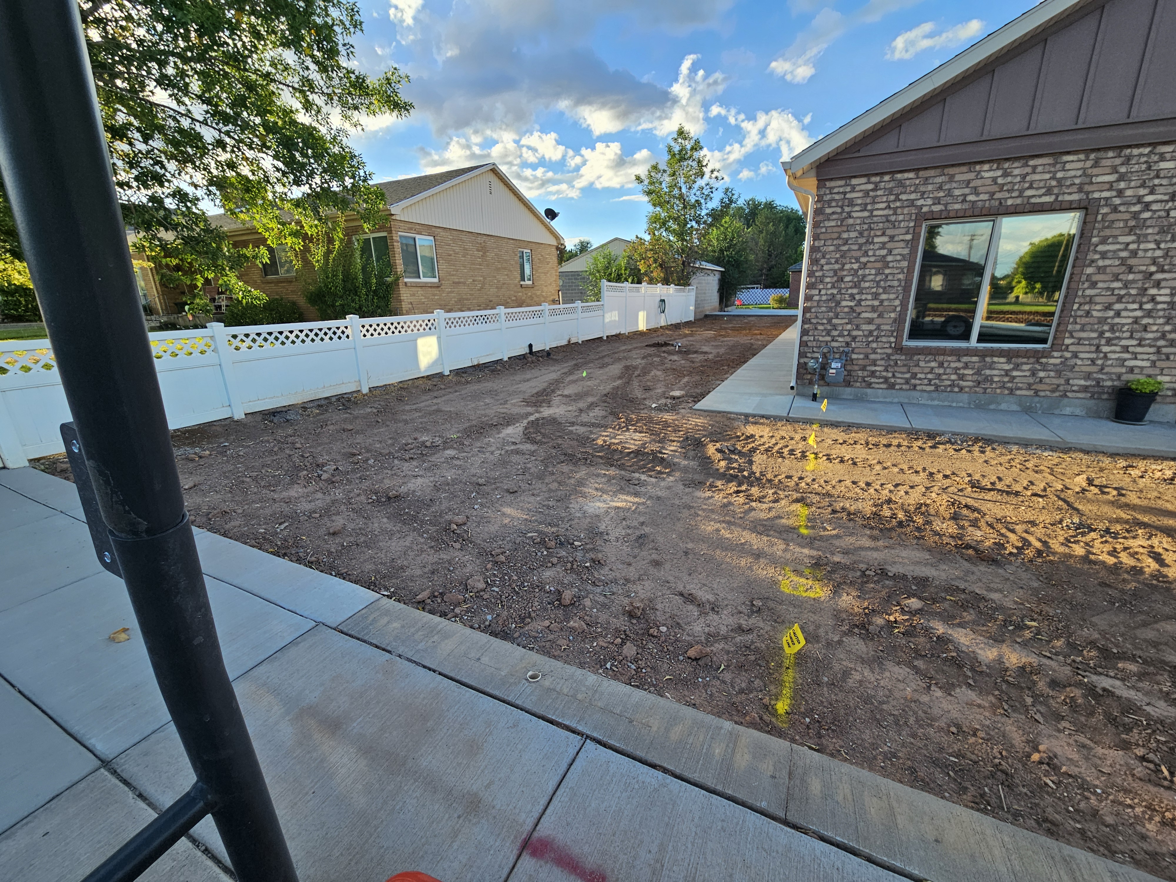 Commercial building entrance landscaped with seasonal color plantings, shrubs, and stone features